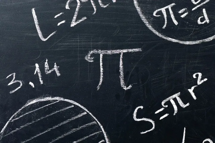 A blackboard covered in chalk-written pi formulas, the pi symbol, and 3.14.