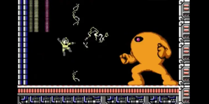 NES-era pixel art screenshot of a small character shooting at a large orange blob enemy.