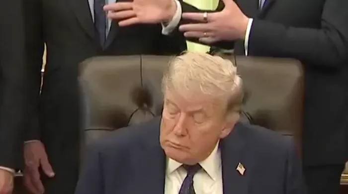 Close-up of Trump seated with eyes closed and head drooping, appearing to be asleep at official event.