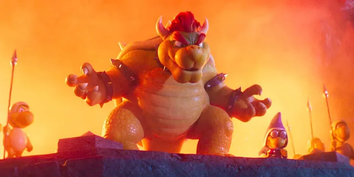 Animated Bowser looms menacingly over minions surrounded by fiery orange light.